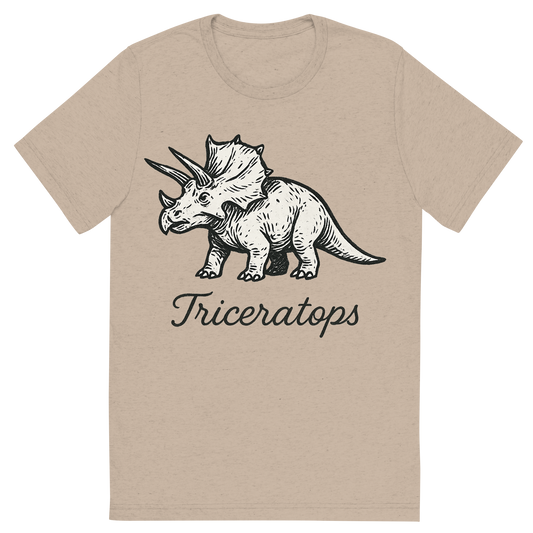 Front view of a Premium Tri-Blend Crew Neck T-Shirt in Tan showing 'A flat, neutral graphic of a stylized sketch of a triceratops with three horns and a frilled head. “triceratops” appears in graceful cursive below. ink illustration on a white background.'