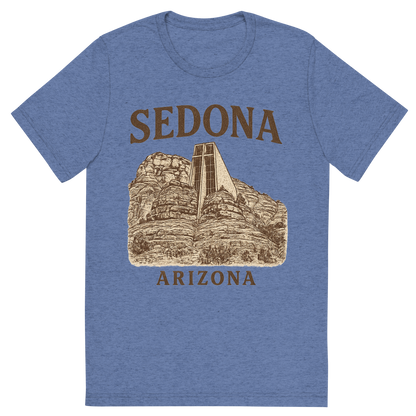 Front view of a Premium Tri-Blend Crew Neck T-Shirt in Blue showing 'A typographic, nostalgic graphic of a typographic illustration of the words 'sedona, arizona' with a vintage line art drawing of the chapel of the holy cross'