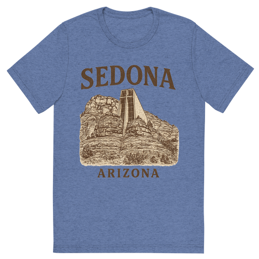 Front view of a Premium Tri-Blend Crew Neck T-Shirt in Blue showing 'A typographic, nostalgic graphic of a typographic illustration of the words 'sedona, arizona' with a vintage line art drawing of the chapel of the holy cross'