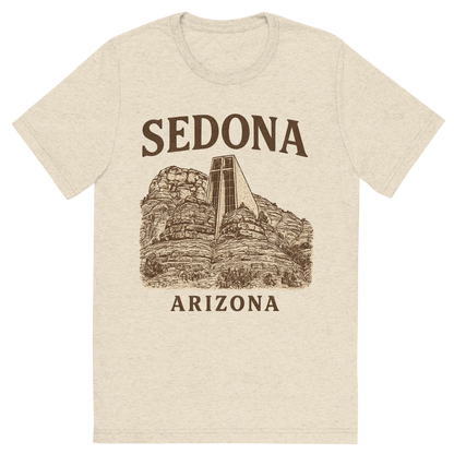 Front view of a Premium Tri-Blend Crew Neck T-Shirt in Oatmeal showing 'A typographic, nostalgic graphic of a typographic illustration of the words 'sedona, arizona' with a vintage line art drawing of the chapel of the holy cross'