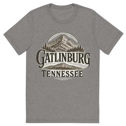 Front view of a Premium Tri-Blend Crew Neck T-Shirt in Grey showing 'A typographic, nostalgic graphic of a typographic illustration of the words 'gatlinburg, tennessee' with a vintage line art drawing of ober mountain'