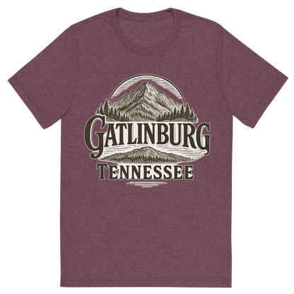 Front view of a Premium Tri-Blend Crew Neck T-Shirt in Maroon showing 'A typographic, nostalgic graphic of a typographic illustration of the words 'gatlinburg, tennessee' with a vintage line art drawing of ober mountain'
