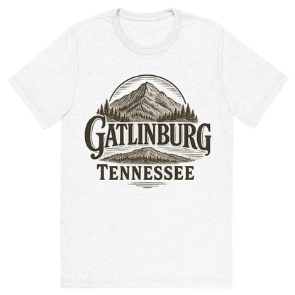 Front view of a Premium Tri-Blend Crew Neck T-Shirt in Solid White showing 'A typographic, nostalgic graphic of a typographic illustration of the words 'gatlinburg, tennessee' with a vintage line art drawing of ober mountain'