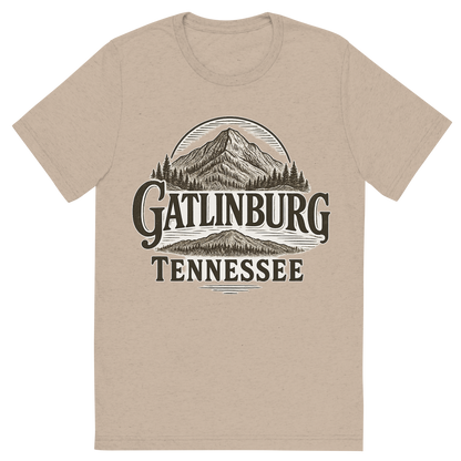 Front view of a Premium Tri-Blend Crew Neck T-Shirt in Tan showing 'A typographic, nostalgic graphic of a typographic illustration of the words 'gatlinburg, tennessee' with a vintage line art drawing of ober mountain'