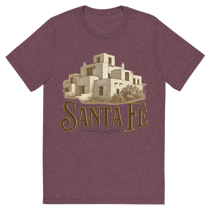Front view of a Premium Tri-Blend Crew Neck T-Shirt in Maroon showing 'A typographic, nostalgic graphic of a typographic illustration of the words 'santa fe' with a vintage line art drawing of the adobe architecture'