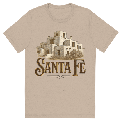 Front view of a Premium Tri-Blend Crew Neck T-Shirt in Tan showing 'A typographic, nostalgic graphic of a typographic illustration of the words 'santa fe' with a vintage line art drawing of the adobe architecture'