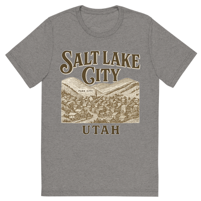 Front view of a Premium Tri-Blend Crew Neck T-Shirt in Grey showing 'A typographic, nostalgic graphic of a typographic illustration of the words 'salt lake city, utah' with a vintage line art drawing of park city'