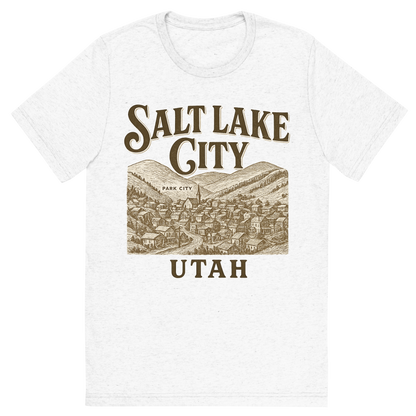 Front view of a Premium Tri-Blend Crew Neck T-Shirt in Solid White showing 'A typographic, nostalgic graphic of a typographic illustration of the words 'salt lake city, utah' with a vintage line art drawing of park city'