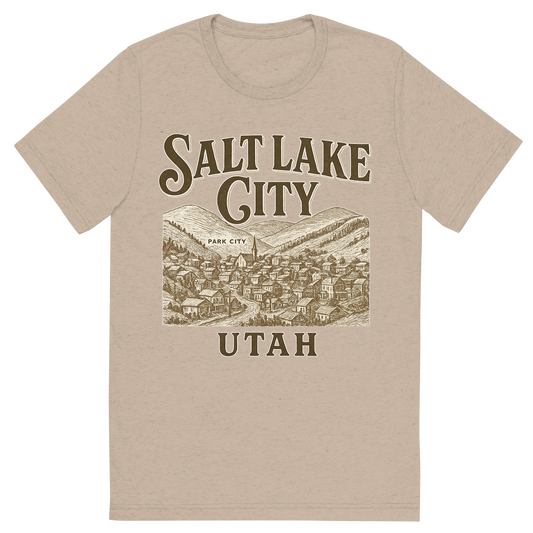 Front view of a Premium Tri-Blend Crew Neck T-Shirt in Tan showing 'A typographic, nostalgic graphic of a typographic illustration of the words 'salt lake city, utah' with a vintage line art drawing of park city'