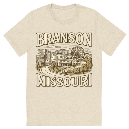 Front view of a Premium Tri-Blend Crew Neck T-Shirt in Oatmeal showing 'A typographic, nostalgic graphic of a typographic illustration of the words 'branson, missouri' with a vintage line art drawing of the branson strip shows'