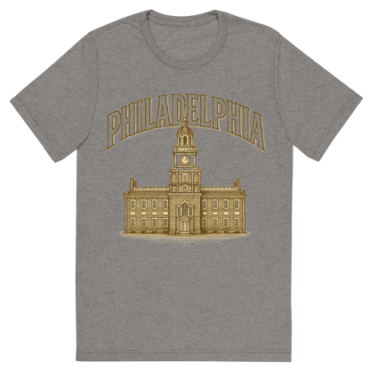 Front view of a Premium Tri-Blend Crew Neck T-Shirt in Grey showing 'A typographic, nostalgic graphic of a typographic illustration of the words 'philadelphia' with a vintage line art drawing of independence hall'
