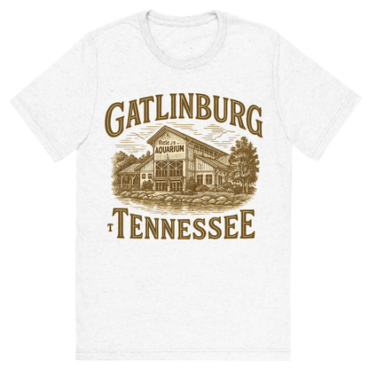 Front view of a Premium Tri-Blend Crew Neck T-Shirt in Solid White showing 'A typographic, nostalgic graphic of a typographic illustration of the words 'gatlinburg, tennessee' with a vintage line art drawing of ripley’s aquarium'