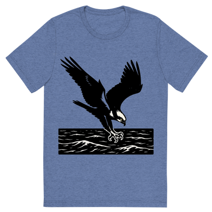 Front view of a Premium Tri-Blend Crew Neck T-Shirt in Blue showing 'A high-contrast silhouette with minimal accent color, powerful graphic of a high-contrast silhouette of an osprey diving with talons extended over the ocean, wings outstretched in dynamic pose, accented with white head markings, transparent background, optimized for dtg printing'