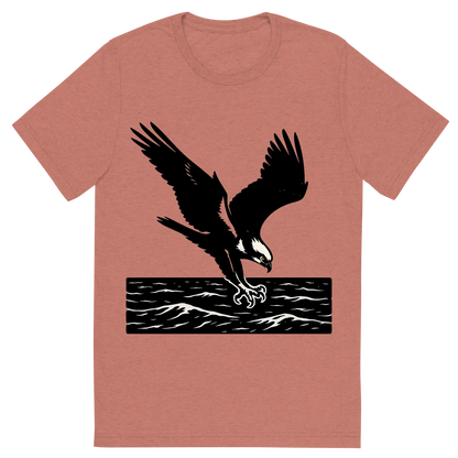 Front view of a Premium Tri-Blend Crew Neck T-Shirt in Mauve showing 'A high-contrast silhouette with minimal accent color, powerful graphic of a high-contrast silhouette of an osprey diving with talons extended over the ocean, wings outstretched in dynamic pose, accented with white head markings, transparent background, optimized for dtg printing'