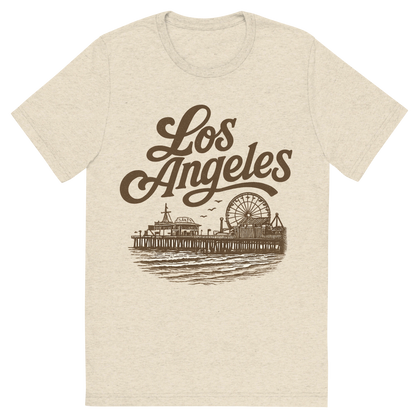 Front view of a Premium Tri-Blend Crew Neck T-Shirt in Oatmeal showing 'A typographic, nostalgic graphic of a typographic illustration of the words 'los angeles' with a vintage line art drawing of santa monica pier'