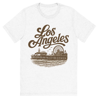 Front view of a Premium Tri-Blend Crew Neck T-Shirt in Solid White showing 'A typographic, nostalgic graphic of a typographic illustration of the words 'los angeles' with a vintage line art drawing of santa monica pier'