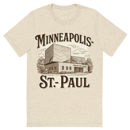 Front view of a Premium Tri-Blend Crew Neck T-Shirt in Oatmeal showing 'A typographic, nostalgic graphic of a typographic illustration of the words 'minneapolis-st. paul' with a vintage line art drawing of the walker art center'