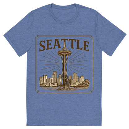 Front view of a Premium Tri-Blend Crew Neck T-Shirt in Blue showing 'A typographic, nostalgic graphic of a typographic illustration of the words 'seattle' with a vintage line art drawing of the space needle'