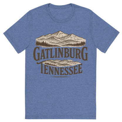 Front view of a Premium Tri-Blend Crew Neck T-Shirt in Blue showing 'A typographic, nostalgic graphic of a typographic illustration of the words 'gatlinburg, tennessee' with a vintage line art drawing of the great smoky mountains'