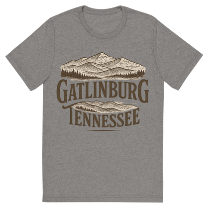 Front view of a Premium Tri-Blend Crew Neck T-Shirt in Grey showing 'A typographic, nostalgic graphic of a typographic illustration of the words 'gatlinburg, tennessee' with a vintage line art drawing of the great smoky mountains'