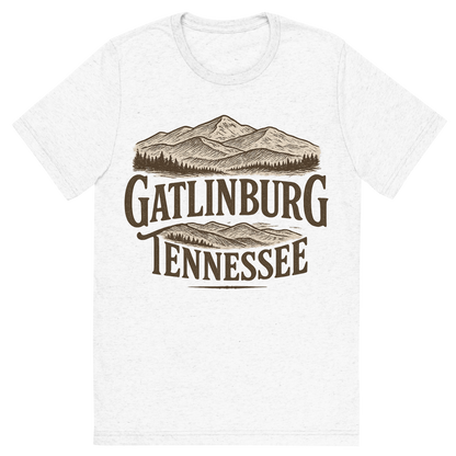 Front view of a Premium Tri-Blend Crew Neck T-Shirt in Solid White showing 'A typographic, nostalgic graphic of a typographic illustration of the words 'gatlinburg, tennessee' with a vintage line art drawing of the great smoky mountains'