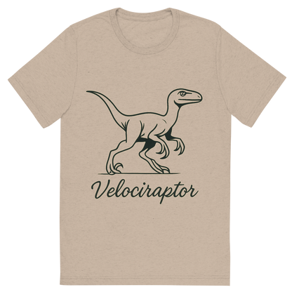 Front view of a Premium Tri-Blend Crew Neck T-Shirt in Tan showing 'A flat, neutral graphic of a sleek sketch of a velociraptor in motion, shown with its sickle claws and alert posture. “velociraptor” is written below in script. ink illustration on a white background.'