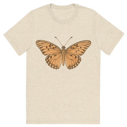 Front view of a Premium Tri-Blend Crew Neck T-Shirt in Oatmeal showing 'A hand-drawn, tranquil graphic of gulf fritillary butterfly'