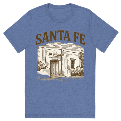 Front view of a Premium Tri-Blend Crew Neck T-Shirt in Blue showing 'A typographic, nostalgic graphic of a typographic illustration of the words 'santa fe' with a vintage line art drawing of the georgia o’keeffe museum'