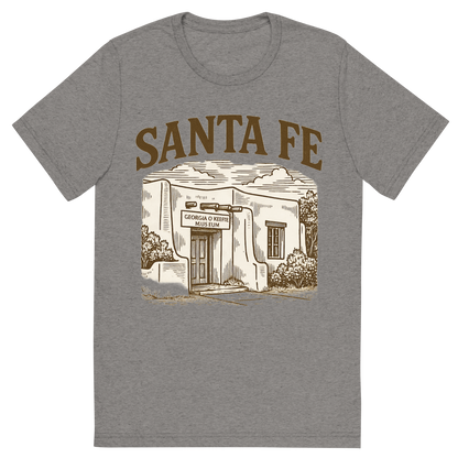 Front view of a Premium Tri-Blend Crew Neck T-Shirt in Grey showing 'A typographic, nostalgic graphic of a typographic illustration of the words 'santa fe' with a vintage line art drawing of the georgia o’keeffe museum'
