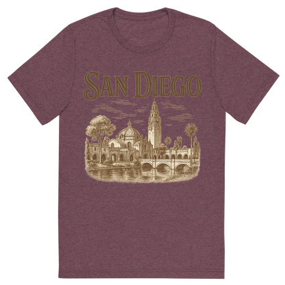 Front view of a Premium Tri-Blend Crew Neck T-Shirt in Maroon showing 'A typographic, nostalgic graphic of a typographic illustration of the words 'san diego' with a vintage line art drawing of balboa park'