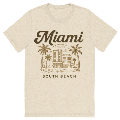 Front view of a Premium Tri-Blend Crew Neck T-Shirt in Oatmeal showing 'A typographic, nostalgic graphic of a typographic illustration of the words 'miami' with a vintage line art drawing of south beach'