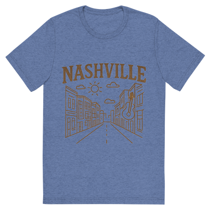 Front view of a Premium Tri-Blend Crew Neck T-Shirt in Blue showing 'A minimalist, playful graphic of a typographic illustration of the words 'nashville' with a vintage line art drawing of broadway street'