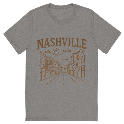Front view of a Premium Tri-Blend Crew Neck T-Shirt in Grey showing 'A minimalist, playful graphic of a typographic illustration of the words 'nashville' with a vintage line art drawing of broadway street'
