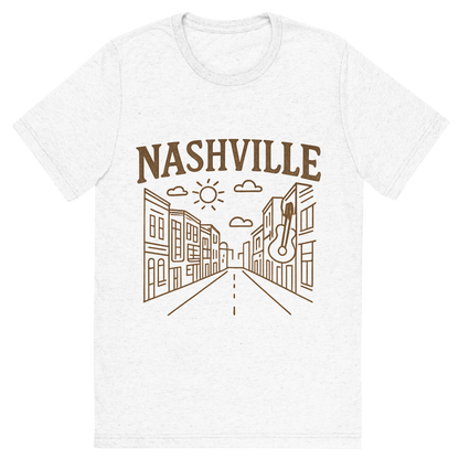 Front view of a Premium Tri-Blend Crew Neck T-Shirt in Solid White showing 'A minimalist, playful graphic of a typographic illustration of the words 'nashville' with a vintage line art drawing of broadway street'