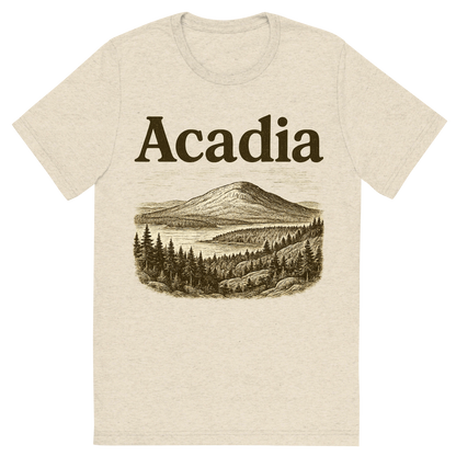 Front view of a Premium Tri-Blend Crew Neck T-Shirt in Oatmeal showing 'A typographic, nostalgic graphic of a typographic illustration of the words 'acadia' with a vintage line art drawing of cadillac mountain'