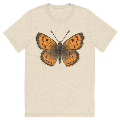 Front view of a Premium Tri-Blend Crew Neck T-Shirt in Oatmeal showing 'A hand-drawn, tranquil graphic of small copper butterfly'