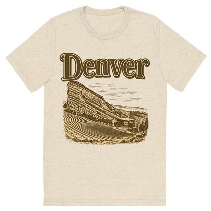 Front view of a Premium Tri-Blend Crew Neck T-Shirt in Oatmeal showing 'A typographic, nostalgic graphic of a typographic illustration of the words 'denver' with a vintage line art drawing of the red rocks amphitheatre'