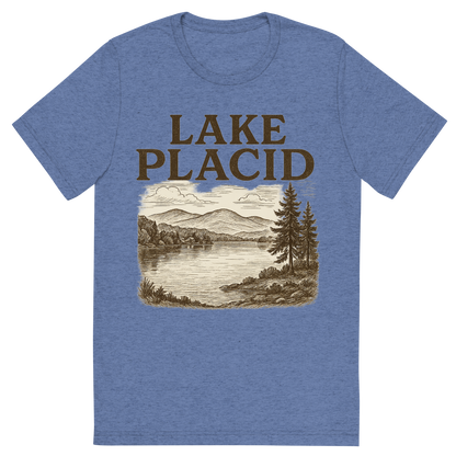 Front view of a Premium Tri-Blend Crew Neck T-Shirt in Blue showing 'A typographic, nostalgic graphic of a typographic illustration of the words 'lake placid' with a vintage line art drawing of mirror lake'