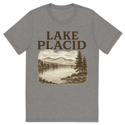 Front view of a Premium Tri-Blend Crew Neck T-Shirt in Grey showing 'A typographic, nostalgic graphic of a typographic illustration of the words 'lake placid' with a vintage line art drawing of mirror lake'