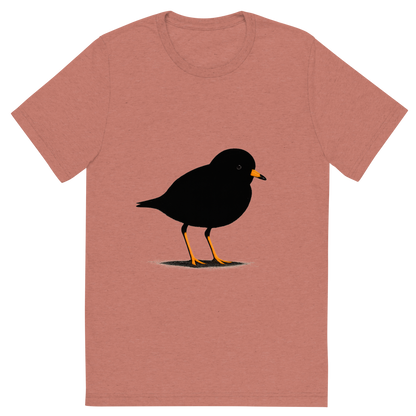 Front view of a Premium Tri-Blend Crew Neck T-Shirt in Mauve showing 'A high-contrast silhouette with minimal accent color, delicate graphic of a small silhouette of a piping plover standing on the sand with orange legs and beak highlighted, transparent background, optimized for dtg printing'