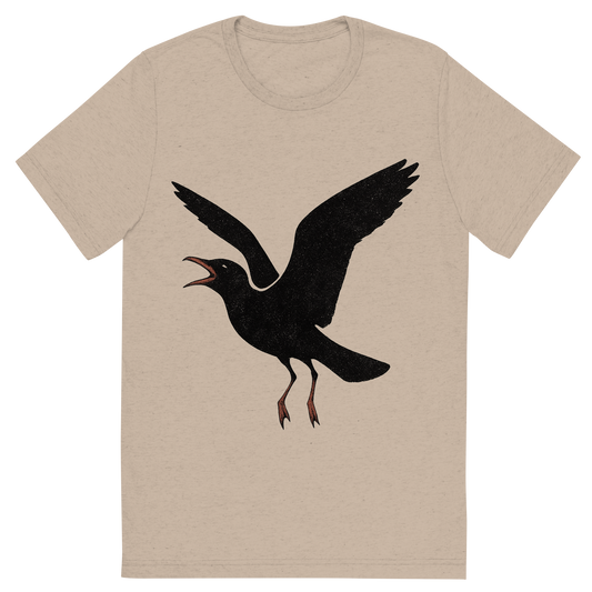 Front view of a Premium Tri-Blend Crew Neck T-Shirt in Tan showing 'A high-contrast silhouette with minimal accent color, noisy graphic of a silhouette of a laughing gull mid-call with open beak and black head, red bill and legs lightly accented, wings open in flight, transparent background, optimized for dtg printing'