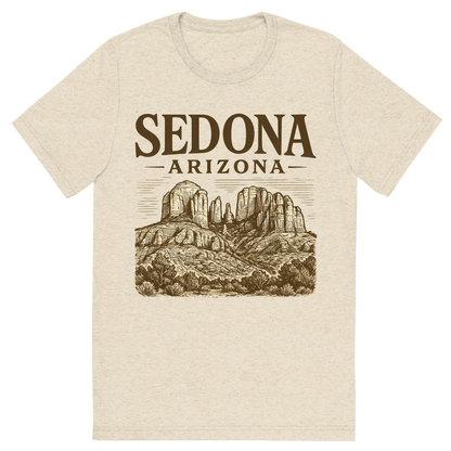 Front view of a Premium Tri-Blend Crew Neck T-Shirt in Oatmeal showing 'A typographic, nostalgic graphic of a typographic illustration of the words 'sedona, arizona' with a vintage line art drawing of the red rock formations'