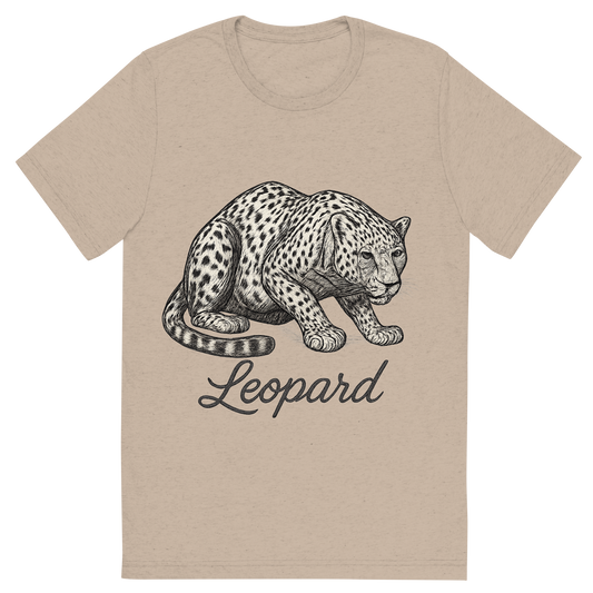 Front view of a Premium Tri-Blend Crew Neck T-Shirt in Tan showing 'A flat, neutral graphic of a drawing of a leopard crouched, with visible spots and muscular build. “leopard” is written beneath in flowing script. detailed ink illustration on a white background.'