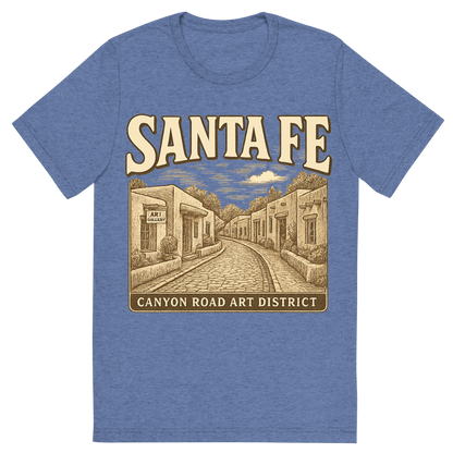 Front view of a Premium Tri-Blend Crew Neck T-Shirt in Blue showing 'A typographic, nostalgic graphic of a typographic illustration of the words 'santa fe' with a vintage line art drawing of the canyon road art district'