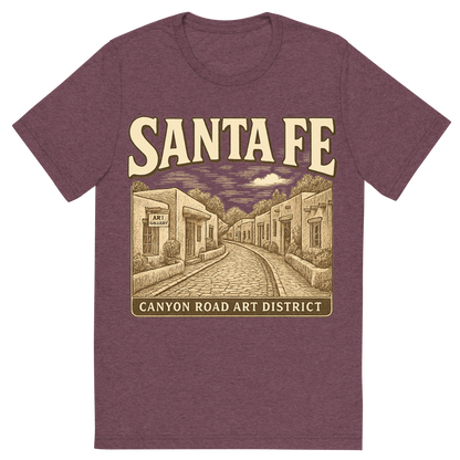 Front view of a Premium Tri-Blend Crew Neck T-Shirt in Maroon showing 'A typographic, nostalgic graphic of a typographic illustration of the words 'santa fe' with a vintage line art drawing of the canyon road art district'