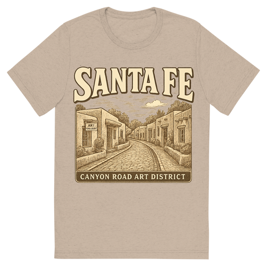 Front view of a Premium Tri-Blend Crew Neck T-Shirt in Tan showing 'A typographic, nostalgic graphic of a typographic illustration of the words 'santa fe' with a vintage line art drawing of the canyon road art district'