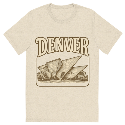 Front view of a Premium Tri-Blend Crew Neck T-Shirt in Oatmeal showing 'A typographic, nostalgic graphic of a typographic illustration of the words 'denver' with a vintage line art drawing of the denver art museum'