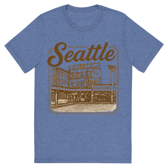 Front view of a Premium Tri-Blend Crew Neck T-Shirt in Blue showing 'A typographic, nostalgic graphic of a typographic illustration of the words 'seattle' with a vintage line art drawing of the pike place market'