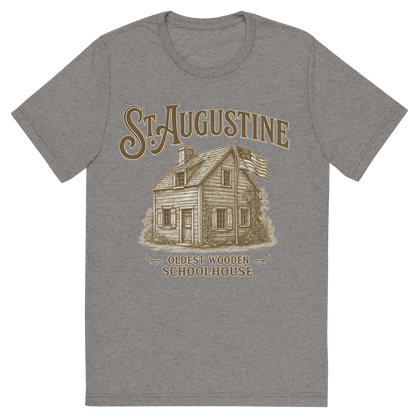 Front view of a Premium Tri-Blend Crew Neck T-Shirt in Grey showing 'A typographic, nostalgic graphic of a typographic illustration of the words 'st. augustine' with a vintage line art drawing of the oldest wooden schoolhouse'