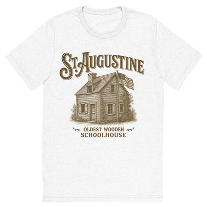 Front view of a Premium Tri-Blend Crew Neck T-Shirt in Solid White showing 'A typographic, nostalgic graphic of a typographic illustration of the words 'st. augustine' with a vintage line art drawing of the oldest wooden schoolhouse'